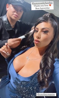 a woman is getting her hair done by a man