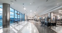 an airport with a long line of people waiting to check in
