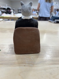 a cat sitting on top of a wooden table