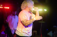 a man singing into a microphone at a concert