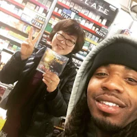 a man and woman standing next to each other in a store