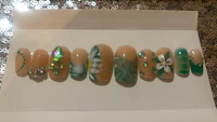 a card with green and white nail art on it