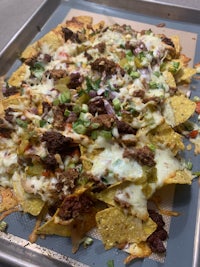 a tray of nachos on a baking sheet