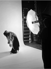 a black and white photo of a woman in a studio