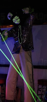 a man in a suit with a green laser