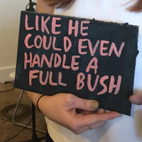 a woman holding a sign that says like he could even handle a full bush