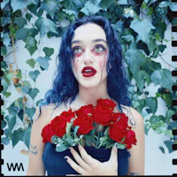 a woman holding a bouquet of red roses