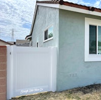 a house with a white fence and a window