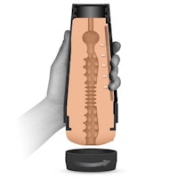 a hand holding a bottle with a sex toy inside