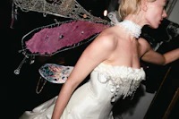 a woman in a wedding dress with wings
