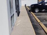 a black truck is parked in front of a building