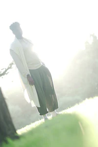 a man standing in a field with a frisbee