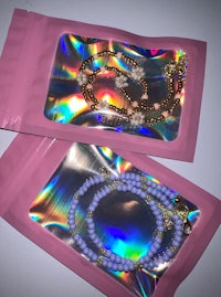 holographic bracelets in pink pouches