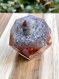a glass sphere with a red, white, and blue stone in it