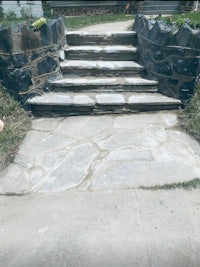 a stone stairway in front of a house