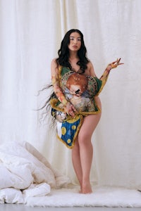 a woman posing naked on a bed