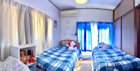 a small bedroom with two beds and a teddy bear