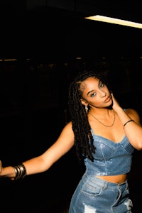 a woman wearing a denim skirt