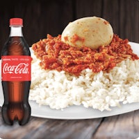 a plate with rice and a bottle of coca cola