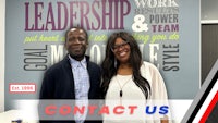 two people standing in front of a wall with the words leadership and team