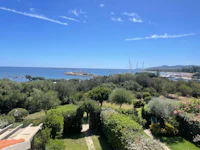 a view of the sea from a house in a garden