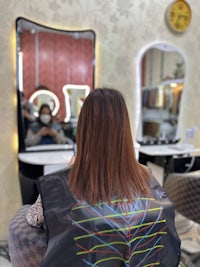 a woman is getting her hair done in a salon