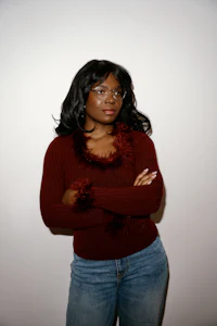 a black woman in a burgundy sweater and jeans
