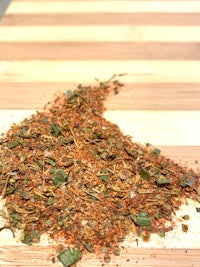 a pile of herbs and spices on a wooden table