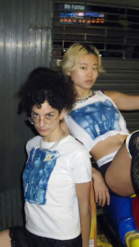 two women posing on a toy car