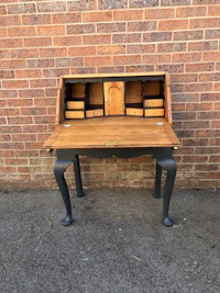 a desk with a wooden top and black legs