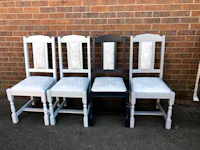four chairs with a white seat and a black seat