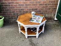 an octagonal side table with a magazine on it