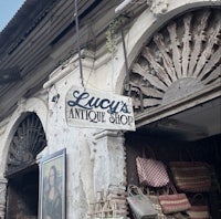 an old building with a sign that says lucky's antique shop