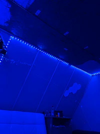 a bed in a room with blue lights