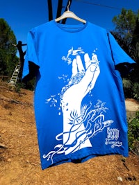 a blue t - shirt with an image of a hand