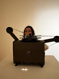 a woman is standing on top of a projector