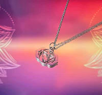 a silver necklace with a flower on it