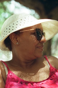 a woman wearing a hat and sunglasses