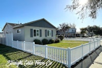a white picket fence in front of a house