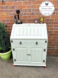 a white cabinet with a clock on top