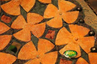 a piece of wood with orange flowers on it