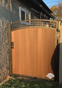 a wooden gate in front of a house