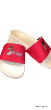 a pair of red and white sandals with an image of a girl