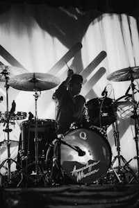 a black and white photo of a drummer on stage