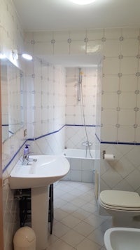 a bathroom with a sink, toilet and shower