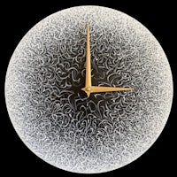a black and white clock with a pattern on it