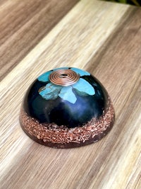 a blue and copper flower on a wooden table