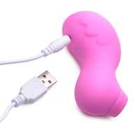 a pink sex toy connected to a usb cable
