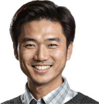 a smiling asian man in a gray sweater