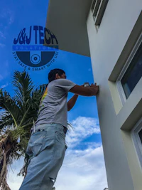 a man is painting the side of a house